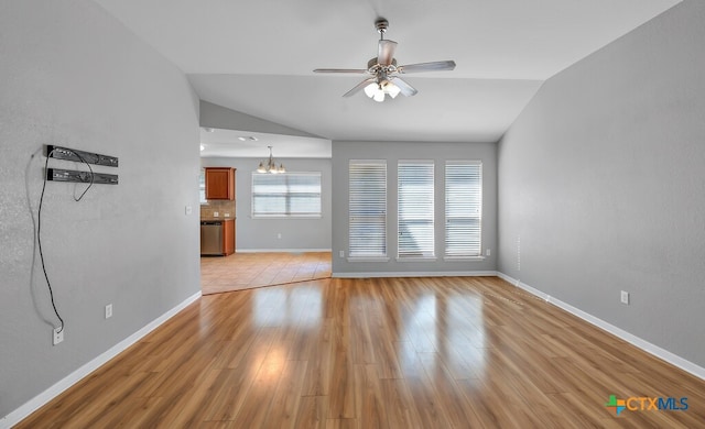 unfurnished living room featuring ceiling fan with notable chandelier, light hardwood / wood-style flooring, and lofted ceiling