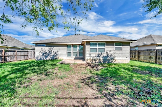 back of property featuring a lawn