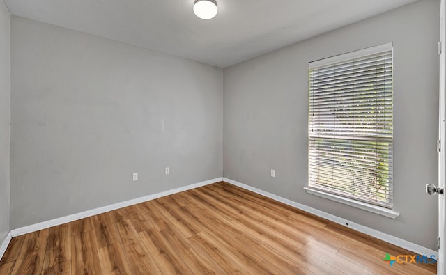 spare room with light hardwood / wood-style floors