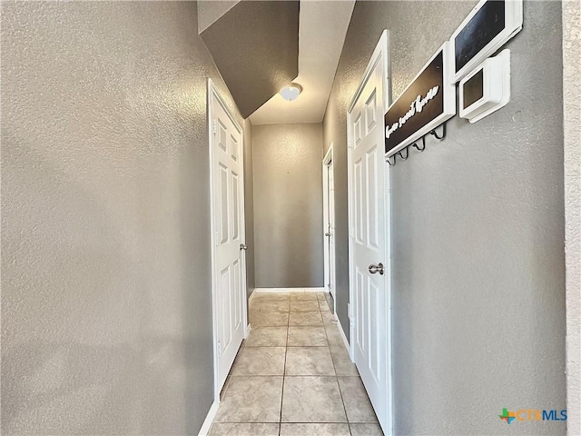 corridor with light tile patterned floors