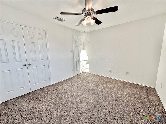 unfurnished bedroom with ceiling fan, a closet, and carpet floors