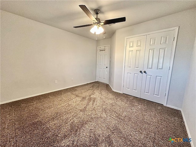 unfurnished bedroom featuring ceiling fan, a closet, and dark colored carpet