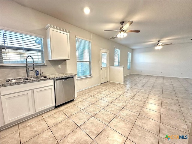 kitchen featuring ceiling fan, light tile patterned flooring, dishwasher, white cabinets, and sink