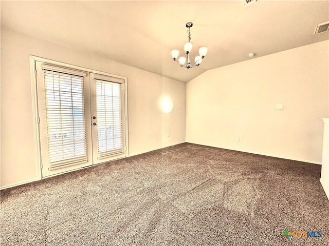 carpeted spare room with a notable chandelier