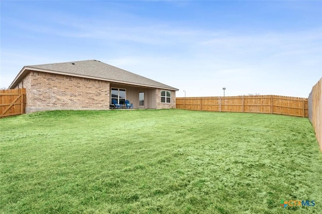 1306 Campbelton Dr, Temple, TX 76504 - rear view of property featuring a fenced backyard, brick siding, and a shingled roof