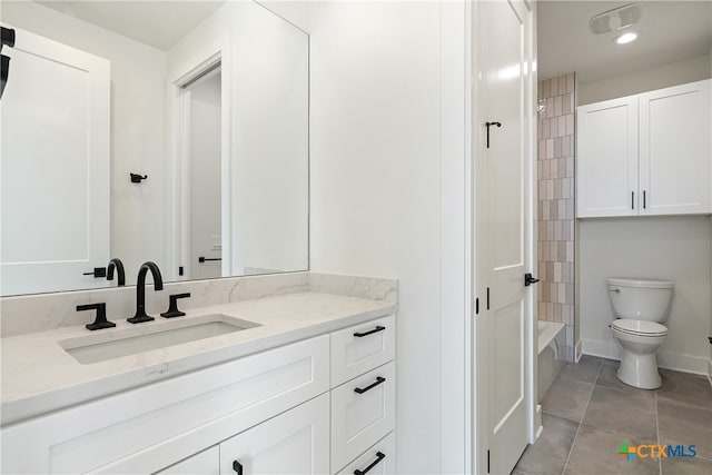 full bathroom with tile patterned floors, vanity, toilet, and tiled shower / bath combo