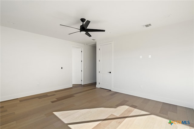 empty room with hardwood / wood-style flooring and ceiling fan