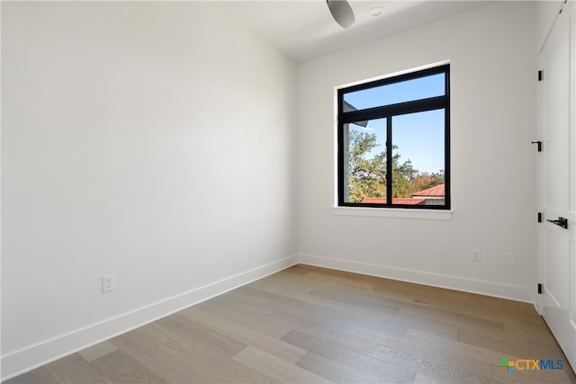 empty room with light hardwood / wood-style flooring