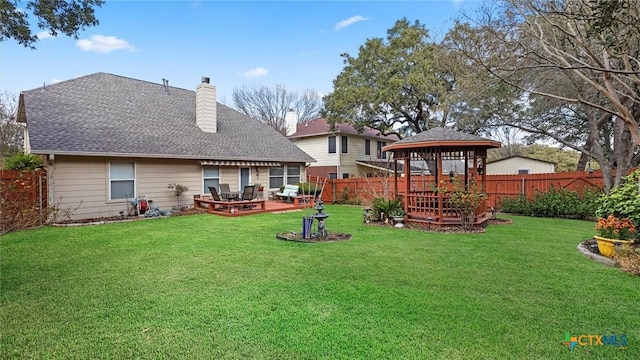 rear view of house featuring a patio area, a fenced backyard, a lawn, and a gazebo