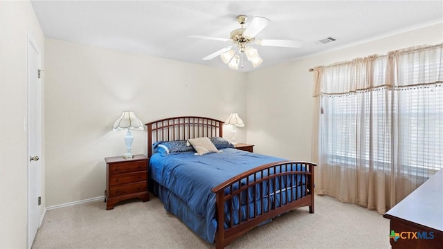 bedroom with carpet, visible vents, and ceiling fan