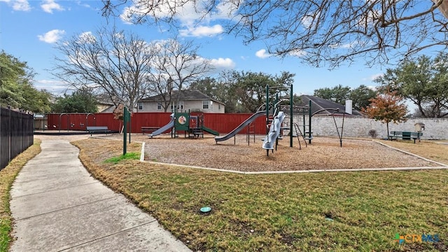 community playground with fence and a lawn