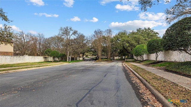 view of road with curbs and sidewalks