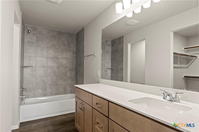 192 Lavender Ln, Elgin, TX 78621 - bathroom with a spacious closet, bathing tub / shower combination, wood finished floors, and vanity