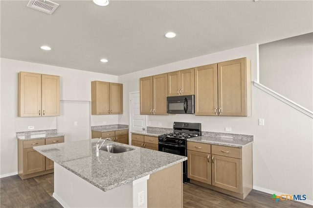 192 Lavender Ln, Elgin, TX 78621 - kitchen with dark wood-style flooring, visible vents, light stone countertops, a sink, and black appliances