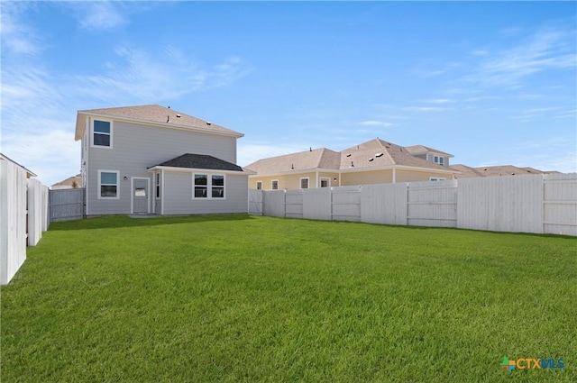 192 Lavender Ln, Elgin, TX 78621 - rear view of house with a lawn and a fenced backyard