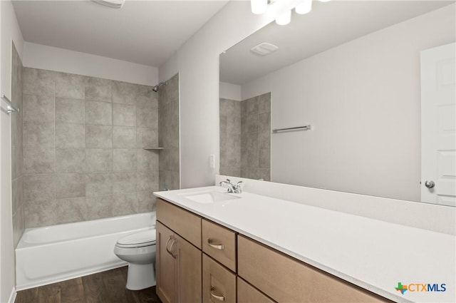 192 Lavender Ln, Elgin, TX 78621 - bathroom featuring toilet,  shower combination, wood finished floors, and vanity