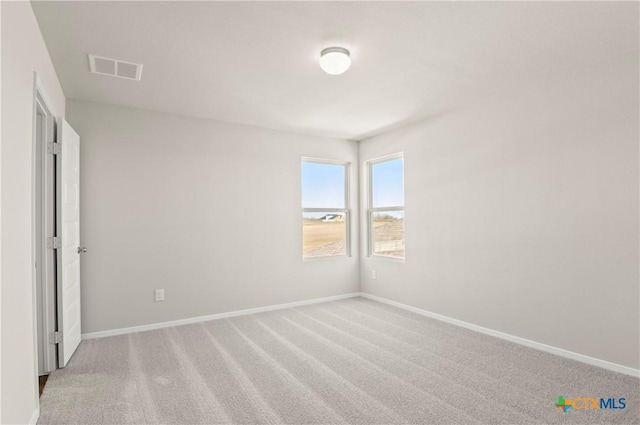 192 Lavender Ln, Elgin, TX 78621 - unfurnished bedroom with baseboards, visible vents, and light carpet