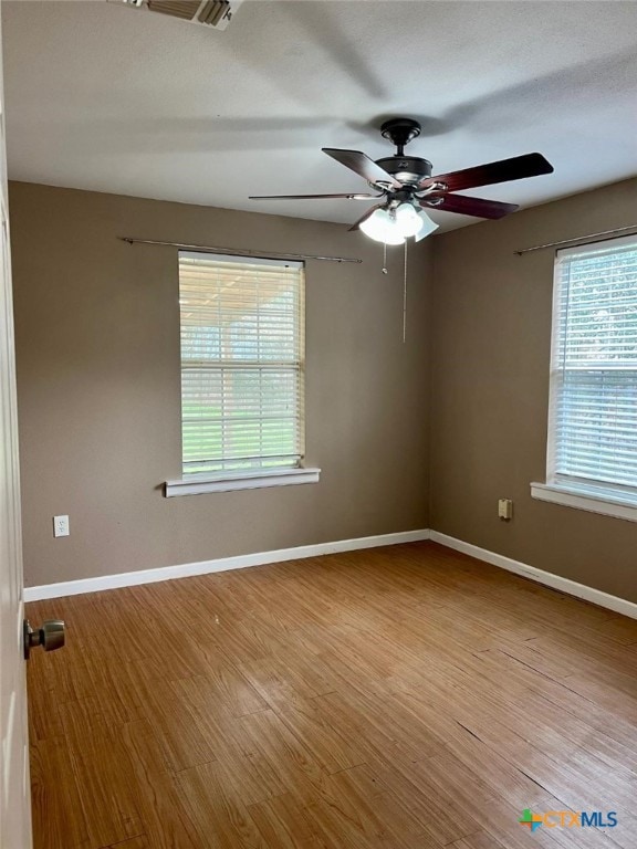 spare room featuring ceiling fan and light hardwood / wood-style floors