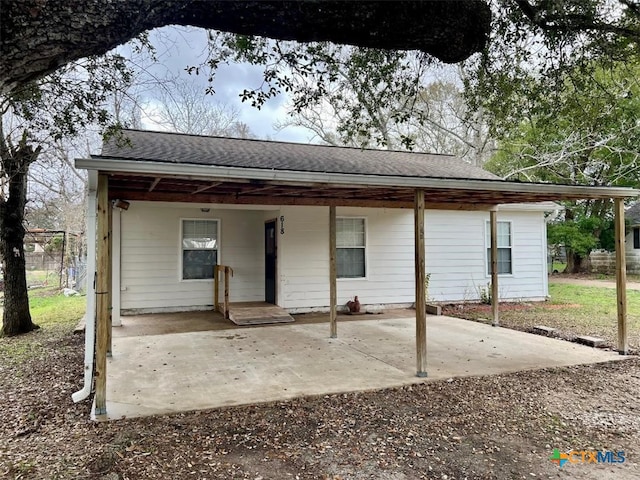 back of property featuring a carport