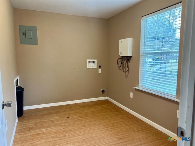 laundry room featuring electric dryer hookup, washer hookup, electric panel, and light wood-type flooring