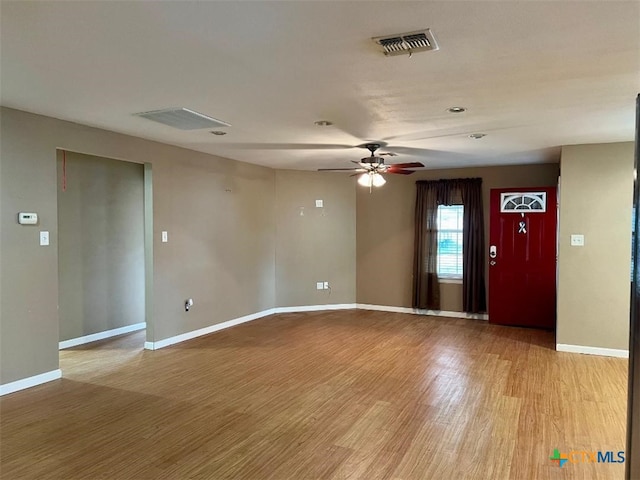 empty room with ceiling fan and light wood-type flooring