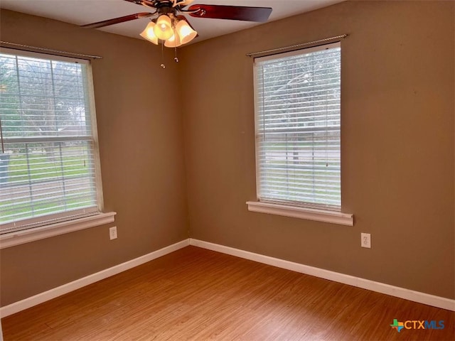 empty room featuring hardwood / wood-style flooring and ceiling fan