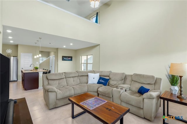 tiled living room featuring a high ceiling and sink