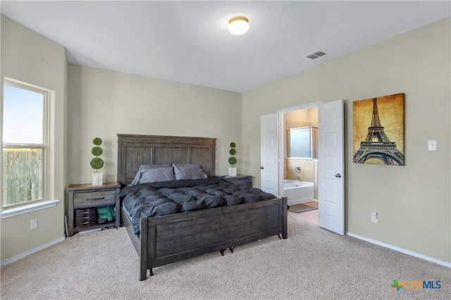 carpeted bedroom with ensuite bath