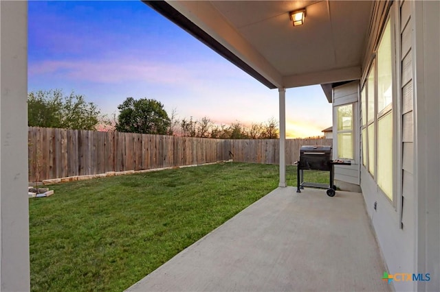 yard at dusk with a patio area