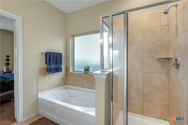 bathroom featuring separate shower and tub