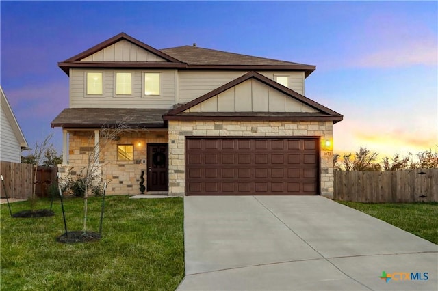 view of front of house featuring a yard and a garage