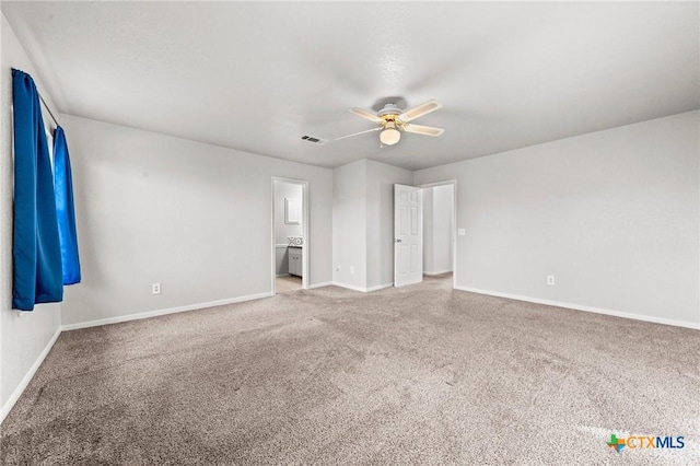 unfurnished bedroom featuring carpet flooring, ceiling fan, and ensuite bath