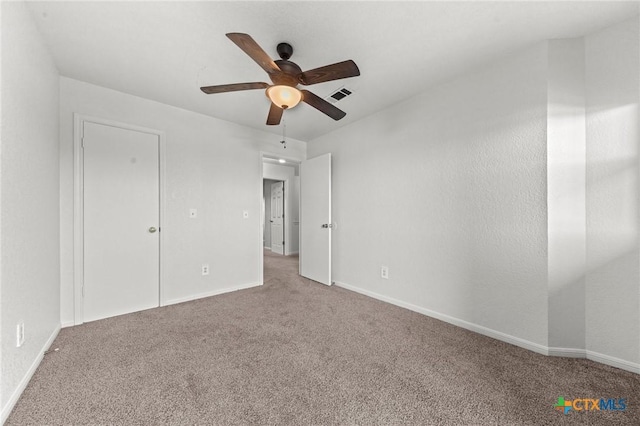 unfurnished bedroom featuring carpet and ceiling fan