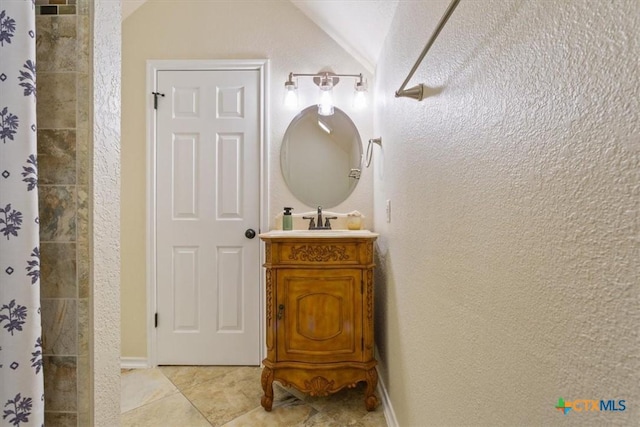 11421 Somerville Dr, Temple, TX 76502 - bathroom featuring lofted ceiling, vanity, tiled shower, and tile patterned floors