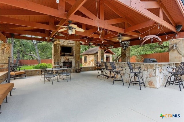 11421 Somerville Dr, Temple, TX 76502 - view of patio with an outdoor stone fireplace, a gazebo, an outdoor kitchen, and a ceiling fan