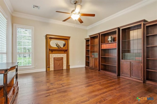 11421 Somerville Dr, Temple, TX 76502 - unfurnished living room with ceiling fan, dark wood-style floors, ornamental molding, and a fireplace