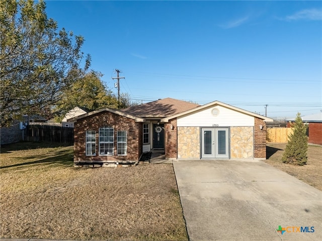 single story home featuring a front lawn and french doors