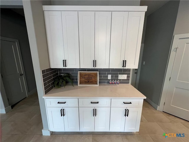 123 S Calvin Barrett, Blanco, TX 78606 - kitchen with decorative backsplash, white cabinets, and light countertops