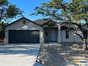 123 S Calvin Barrett, Blanco, TX 78606 - ranch-style home with a garage, driveway, and stucco siding