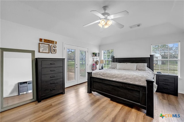 bedroom with a ceiling fan, light wood-style flooring, lofted ceiling, access to exterior, and visible vents