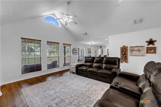 living room with high vaulted ceiling, ceiling fan, a wealth of natural light, and visible vents