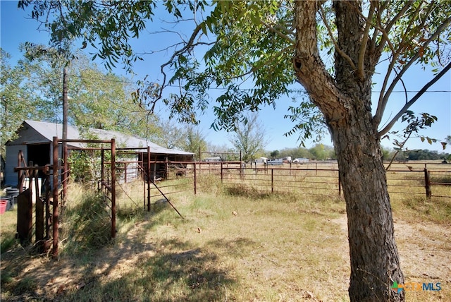 view of yard featuring an outbuilding and a rural view