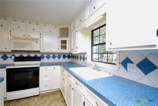 kitchen featuring white cabinetry, tasteful backsplash, white appliances, and sink