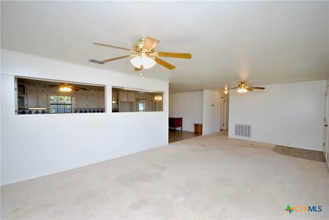 unfurnished living room with ceiling fan and carpet flooring