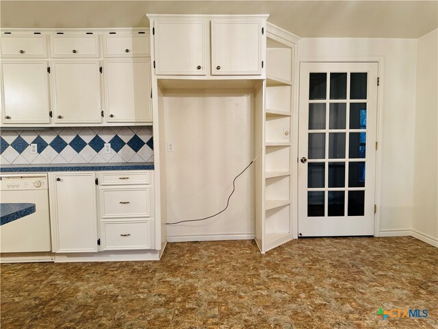 kitchen featuring white cabinetry, decorative backsplash, and white dishwasher