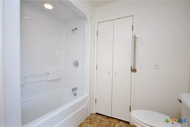 bathroom with shower / bath combination and toilet