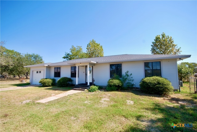 single story home featuring a garage and a front yard