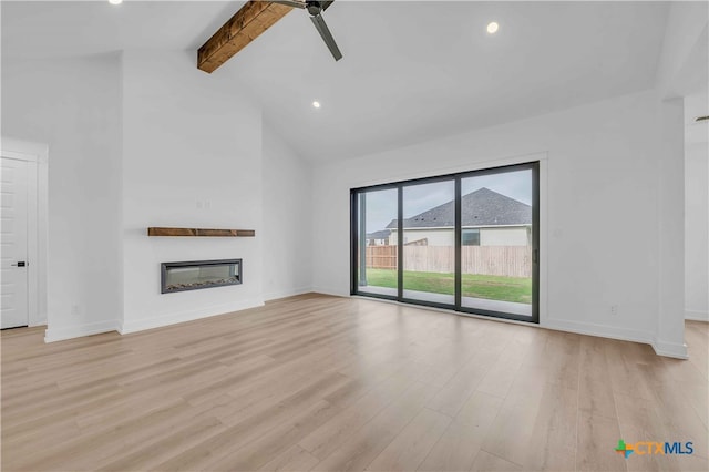 4146 Turning Leaf Dr, Nolanville, TX 76559 - unfurnished living room featuring beam ceiling, light wood-style floors, a glass covered fireplace, a ceiling fan, and baseboards