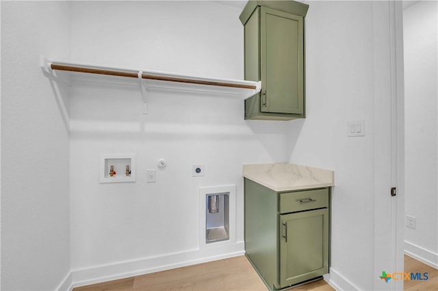 4146 Turning Leaf Dr, Nolanville, TX 76559 - clothes washing area featuring cabinet space, washer hookup, light wood-style flooring, gas dryer hookup, and electric dryer hookup