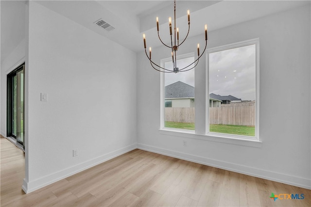 4146 Turning Leaf Dr, Nolanville, TX 76559 - unfurnished dining area featuring visible vents, wood finished floors, a notable chandelier, and a healthy amount of sunlight